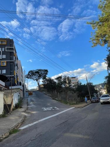 an empty street with a blue sky and clouds at Absolut Residense in João Monlevade