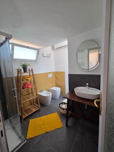 a bathroom with a sink and a toilet and a mirror at A casa di Sonia in Cerreto Guidi