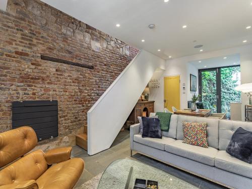 a living room with a brick wall at St Margarets Cottage in King's Lynn