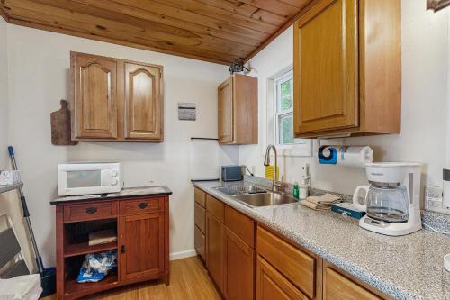 a kitchen with wooden cabinets and a counter top at SunRise Pines in Leeds