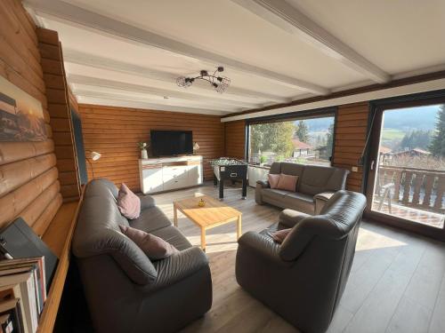 a living room with two couches and a television at Haus 44 Feldblick Fewo 1 oben in Arrach