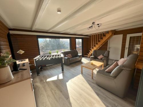 a living room with couches and a table at Haus 44 Feldblick Fewo 1 oben in Arrach