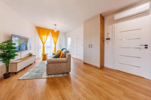 a living room with a couch and a sliding door at Noble Inn Regency, City Centre, Free Parking by StayNest in Rzeszów