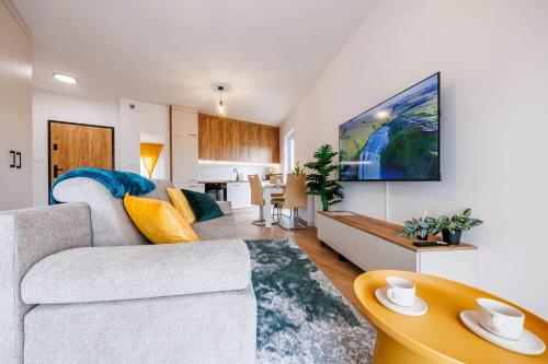 a living room with a couch and a table at Noble Inn Regency, City Centre, Free Parking by StayNest in Rzeszów