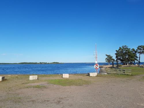 a body of water with a boat in the distance at Cottage on the Småland coast 