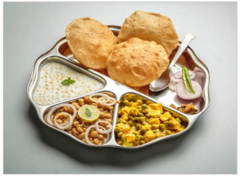 a lunch box filled with different types of food at Le continental in New Delhi