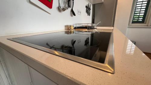 a kitchen counter with a glass window on it at Sea whisper in Lovran