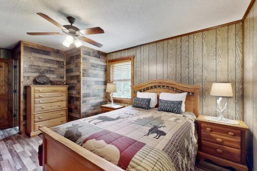 a bedroom with a bed and a ceiling fan at Canoe House in Ellijay