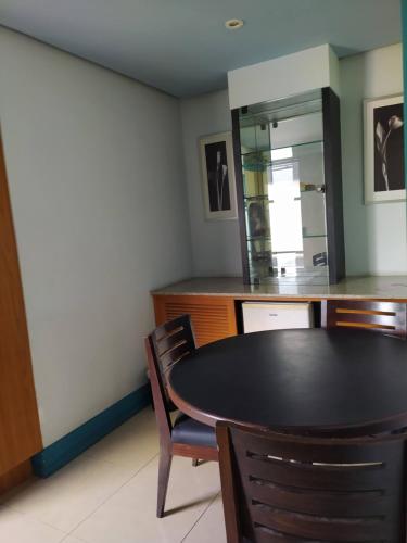 a dining room with a table and chairs and a mirror at Diamond Hotel in Rio de Janeiro