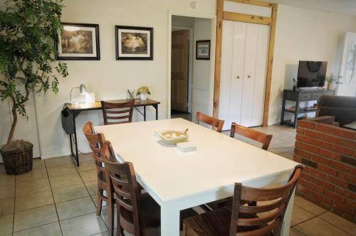 a dining room with a white table and chairs at Centrally located Cozy Mid-Century Home in McComb