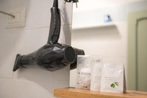 a bathroom sink with a blow dryer and two towels at Casa Vacanze - Platamò in Platamona