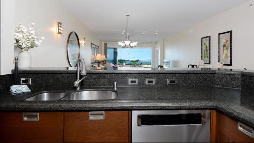 a kitchen with a sink and a mirror at 122 Mariners Club in Key Largo