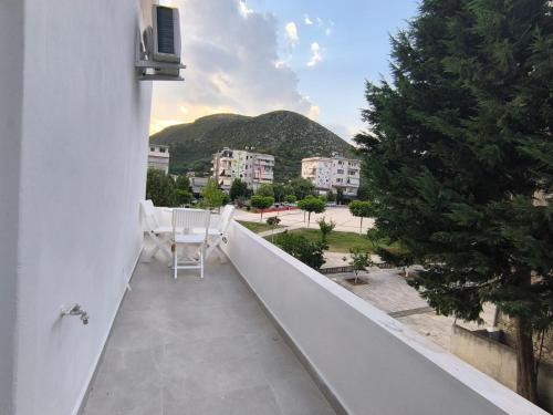 a balcony with a table and chairs on it at Delvina Central Rooms by Mira in Delvinë