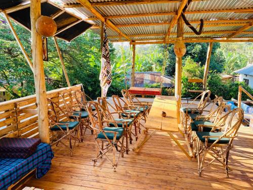 a group of chairs and a table on a deck at Moivaro Eco Hostel in Nkunjila
