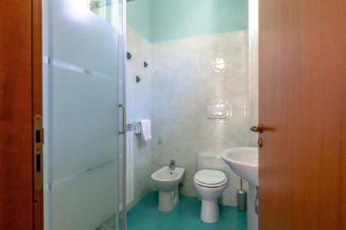 a bathroom with a toilet and a sink at Italian Experience-Sweet Conero in Porto Recanati
