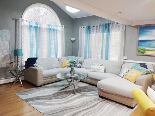 a living room with a couch and a table at 597b) Large 4 bedroom - Pool - Fire Pit in Wolcott