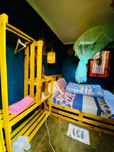 a bedroom with two bunk beds and blue walls at Moivaro Eco Hostel in Nkunjila