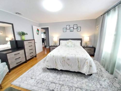 a bedroom with a bed with a white comforter at 597b) Large 4 bedroom - Pool - Fire Pit in Wolcott