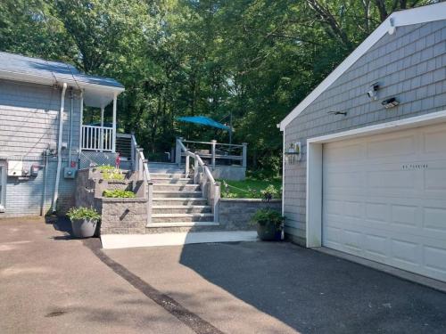 a house with a garage door and a driveway at 597b) Large 4 bedroom - Pool - Fire Pit in Wolcott