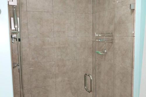 a shower with a glass door in a bathroom at 597b) Large 4 bedroom - Pool - Fire Pit in Wolcott
