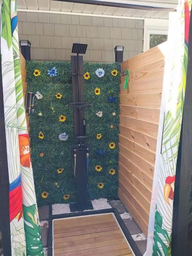 a garden with sunflowers on a fence at 597b) Large 4 bedroom - Pool - Fire Pit in Wolcott
