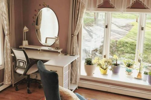 a bathroom with a desk and a mirror and a window at 597b) Large 4 bedroom - Pool - Fire Pit in Wolcott