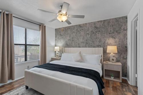 a bedroom with a bed and a ceiling fan at Lux Private Retreat - King Bed in Austin