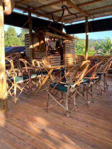 a group of chairs and a table on a deck at Moivaro Eco Hostel in Nkunjila