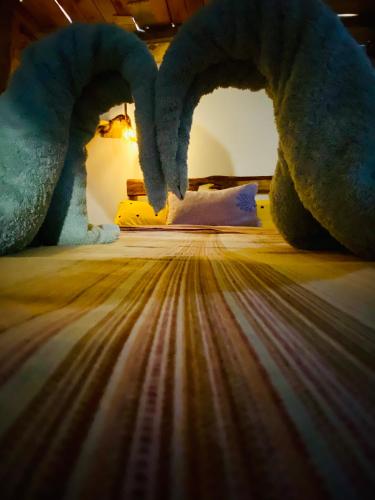 a bed with a stuffed animal on top of it at Moivaro Eco Hostel in Nkunjila