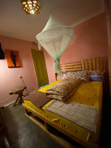 a bedroom with a bed with a mosquito net at Moivaro Eco Hostel in Nkunjila