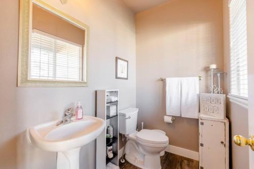 a white bathroom with a sink and a toilet at Prime Location The Village Green Room Desk in Meridian