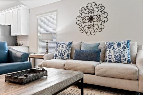 a living room with a couch and a table at Conroe 3BR Sleeps 12 | Fenced Yard + Garage Games in Conroe