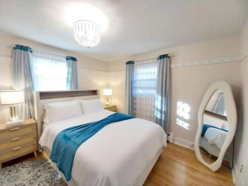 a bedroom with a large bed and a mirror at 597) Sleeps 12 - Pool - Grill in Wolcott