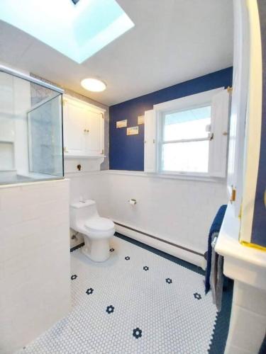 a bathroom with a toilet and a window at 597) Sleeps 12 - Pool - Grill in Wolcott