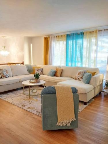 a living room with a couch and a table at 597) Sleeps 12 - Pool - Grill in Wolcott