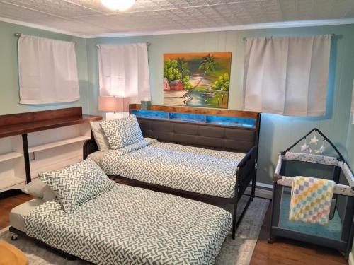 a room with two beds and a couch in it at 597) Sleeps 12 - Pool - Grill in Wolcott