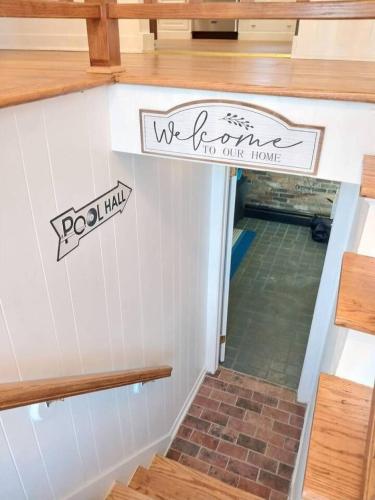 a house with a welcome to our home sign on the wall at 597) Sleeps 12 - Pool - Grill in Wolcott