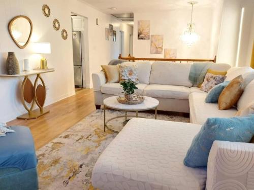 a living room with a white couch and a table at 597) Sleeps 12 - Pool - Grill in Wolcott