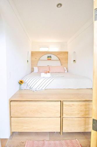 a bedroom with a large bed with a wooden dresser at NEW Atitlan Lakefront, Casa Sabiduria in San Marcos La Laguna
