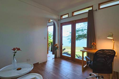 a room with a desk and a table and a chair at NEW Atitlan Lakefront, Casa Sabiduria in San Marcos La Laguna