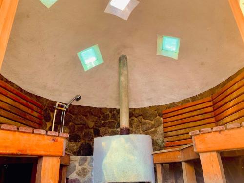 a room with a stone wall with a stove at NEW Atitlan Lakefront, Casa Sabiduria in San Marcos La Laguna