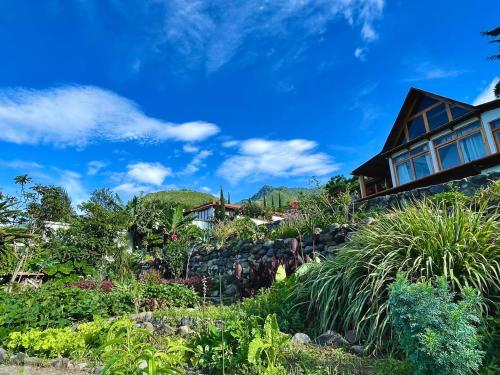 a house on a hill with a garden at NEW Atitlan Lakefront, Casa Sabiduria in San Marcos La Laguna