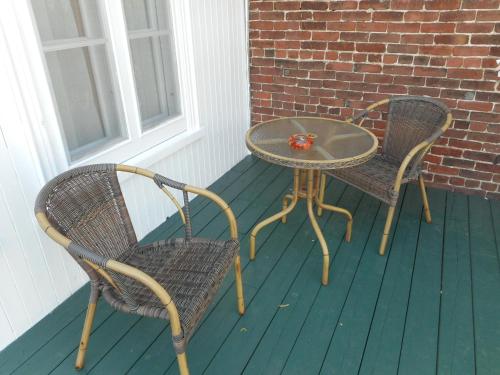 two chairs and a table on a porch at Castel d'Amérique Française in Quebec City