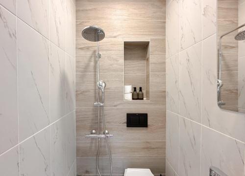 a bathroom with a shower with a toilet at 2 Private Suits - Art, Location, Quiet, Balconies in Sofia