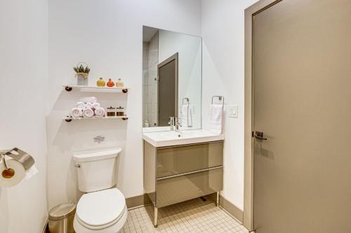 a bathroom with a toilet and a sink at Modern Oasis-lots Of Amenities Including A Pool! 