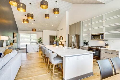 a kitchen with a large white island in a room at Modern Oasis-lots Of Amenities Including A Pool! 