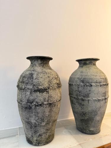 two black vases sitting next to each other at La Clé Boutique Hotel Old Town Marbella in Marbella