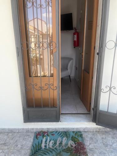 an open door to a room with a chair at House Federica in Melfi