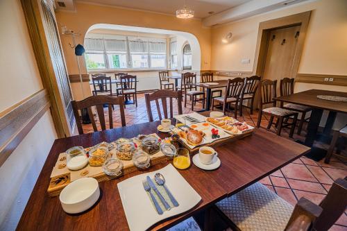 a dining room with a table with food on it at B&B Apartment Racman in Brežice