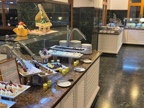 a buffet line with appetizers and desserts in a restaurant at Lahami Bay Beach Resort in Abū Ghuşūn